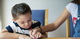 Girl Helping Her Brother To Draw