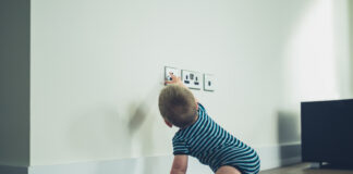 Little Baby Reaching For A Plug Socket