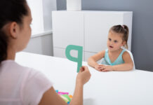 Teacher Teaching Girl To Learn Alphabet