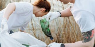 Two people picking up litter