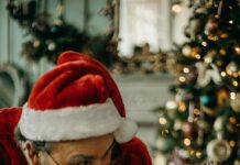 A man dressed as Santa Claus meeting a baby