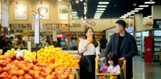 Two adults and a child who appear to be family grocery shop together.