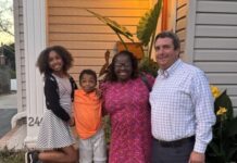 A family standing in front of a house
