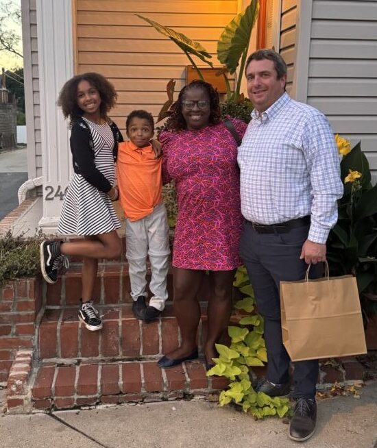 A family standing in front of a house