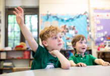 Two students at the Pittsburgh New Church School, one is raising his hand