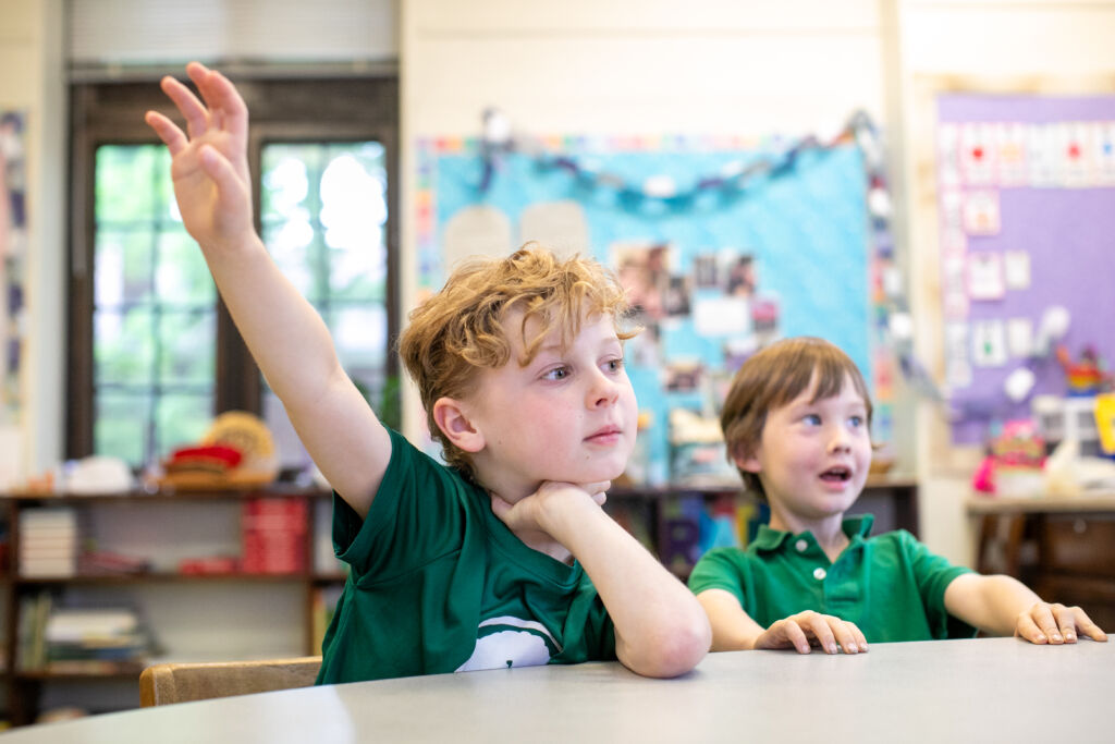 Two students at the Pittsburgh New Church School, one is raising his hand