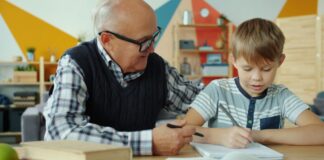 An old man and a child looking at a book
