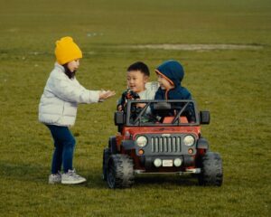 Kids riding a toy Jeep