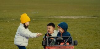 Kids riding a toy Jeep