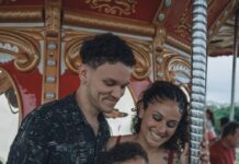 A young boy and his parents ride a carousel