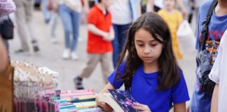 Girl looking at a book at a book fair