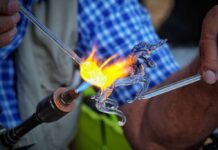 Glass being blown into the shape of a unicorn
