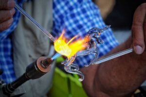 Glass being blown into the shape of a unicorn